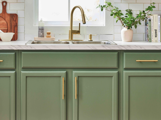 Close-up of modern brushed nickel hardware on freshly painted kitchen cabinets in a rental property upgradehome improvements
